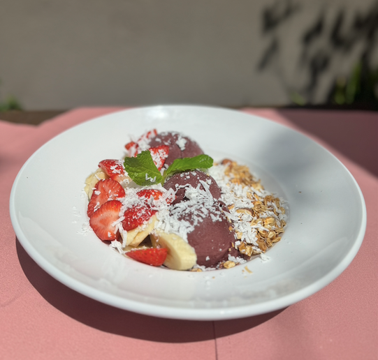 Acai bowl with banana, strawberries, coconut flakes, and granola