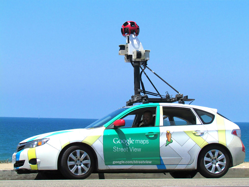 Blue sky, beach boardwalk, a driver sits in a Zoek Marketing partner Google Maps Street View car equipped with a special camera.