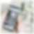 Close up of Zoek Marketing paid ads client's hands holding a smartphone. The screen shows an interior design gallery with relevant keywords at the top. Glass vases with white flowers are in the light background.
