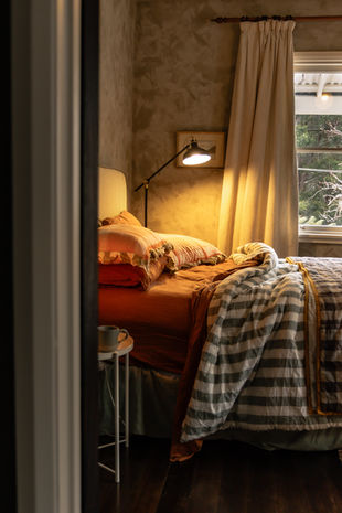 Queen bedroom at Myrtle Creek Farm with french linens overlooking gardens