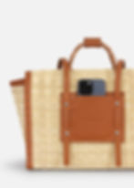 Handwoven oversized Portuguese basket bag in natural reed, featuring a braided wicker handle and genuine leather structure
