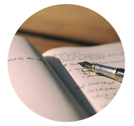 An ink pen on a paper notebook with a list written on it.