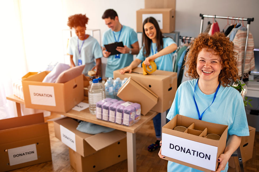 Woman and her colleague working in homeless shelter. Cheerful food drive manager. Happy di