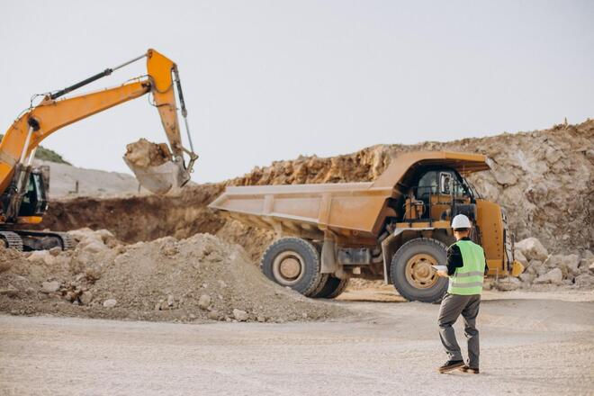 High angle view of open-pit mining operation with heavy machinery