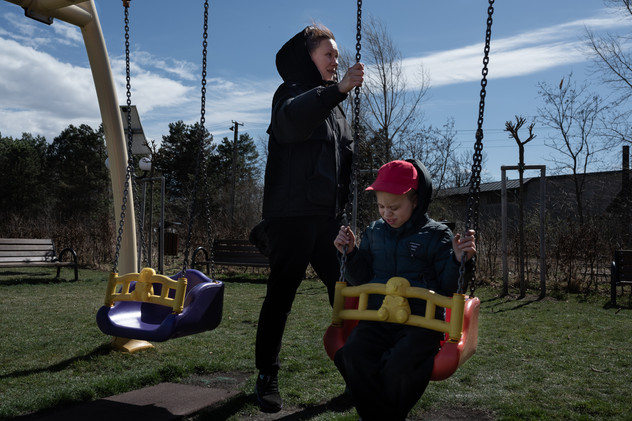 April 2022 | Maria and Sergiy at a playground in Siret, Romania. Maria, 35 years old is traveling with a group of three autistic and disabled kids, along with her own son Sasha. She has left another son back in Ukraine in order to bring these kids to a safe country in Europe. She doesn't know when she will return to Ukraine, but she knows it will be months.