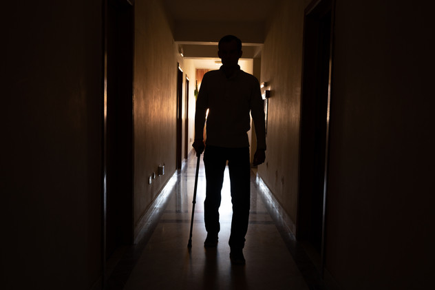 April 2022 | Artem K, 32 years old, walks towards his room at the Congregatia Flicelor Stinten Maria a Divinae Providentia, Iași, Romania. Artem is part of a group of disabled adults and he's waiting to be transferred to a facilities with more appropriate medical settings, in order to continue his treatments.