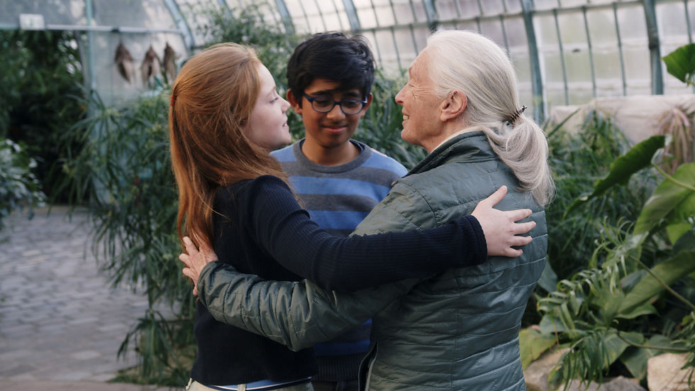 Still from the documentary Animal, showing two teenagers hug environmental activist Jane Goodall