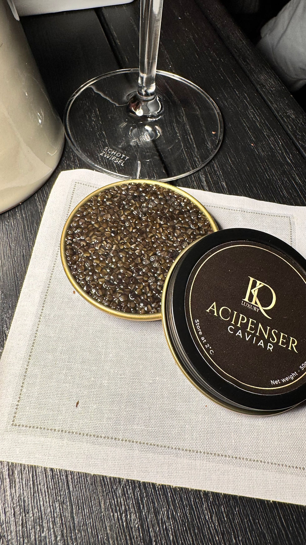 Open tin of Acipenser premium caviar London on a napkin