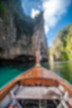 traditional-wooden-longtail-taxi-boat-nose-with-decoration-flowers-ribbons-maya-bay-beach-