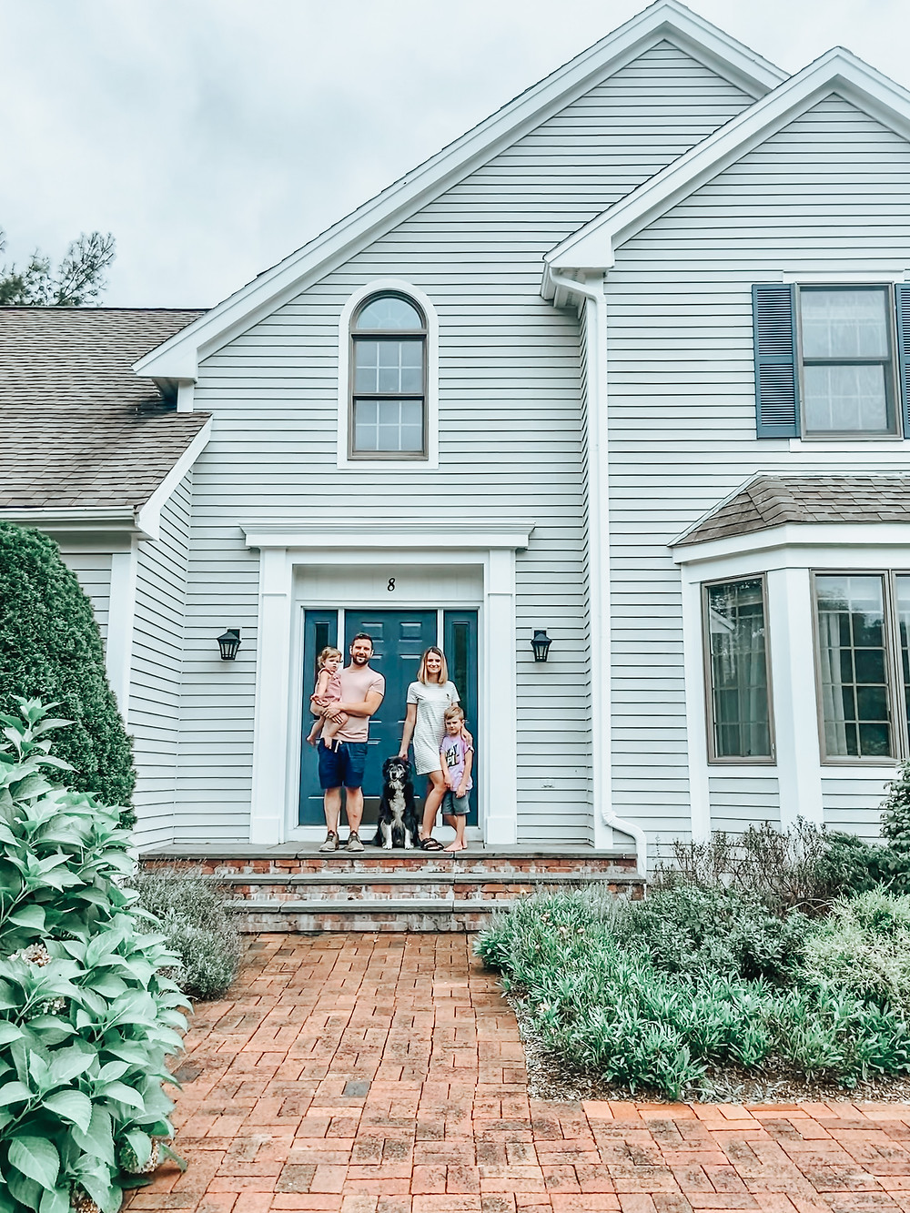 Family portrait in front of new house