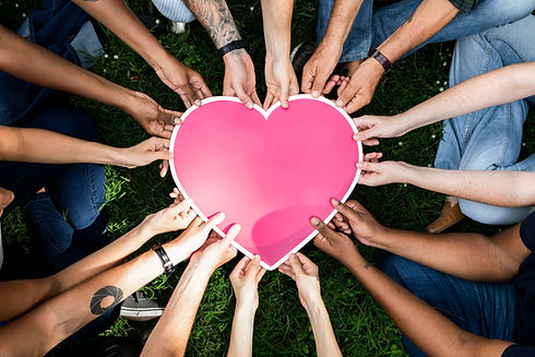 Group of people holding a pink heart ico