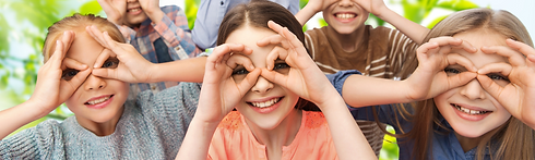 girl looking through hands in glasses shape