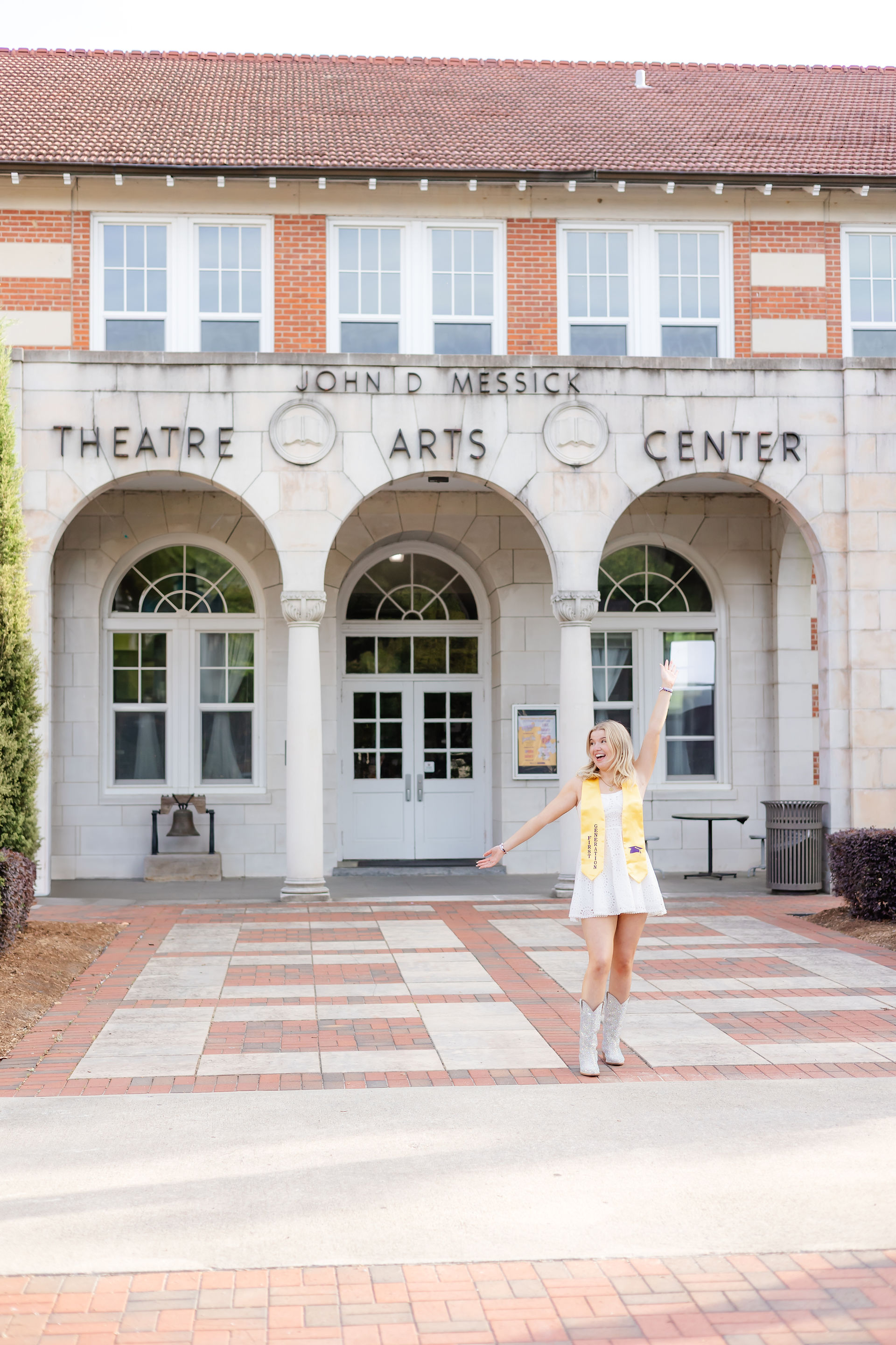 ECU senior standing outside Theatre Arts Center building at East Carolina University.