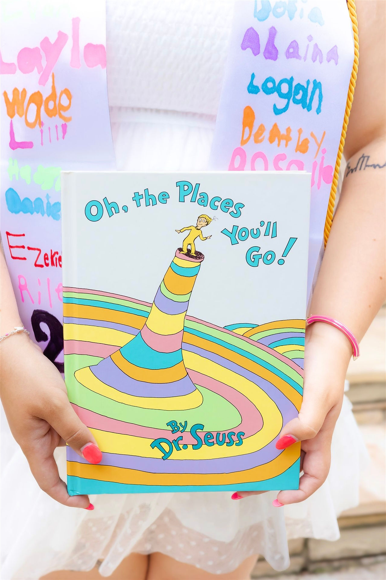 Close up of ECU senior holding favorite book as part of personalized graduation photo session.
