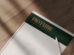 A letterhead on a wooden table with a pencil. It has a green header with text "Moture Apparel & Lifestyle Pvt. Ltd." and contact info.