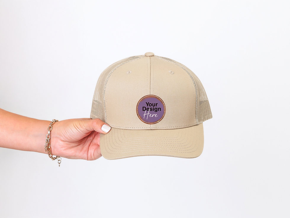 Hand holding a custom beige hat with 'Your Design Here' label' text
