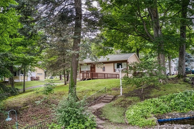 brown cabins in the woods with a staircase in front