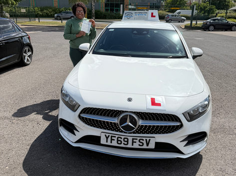 Learner driver showing driving test pass certificate with smile