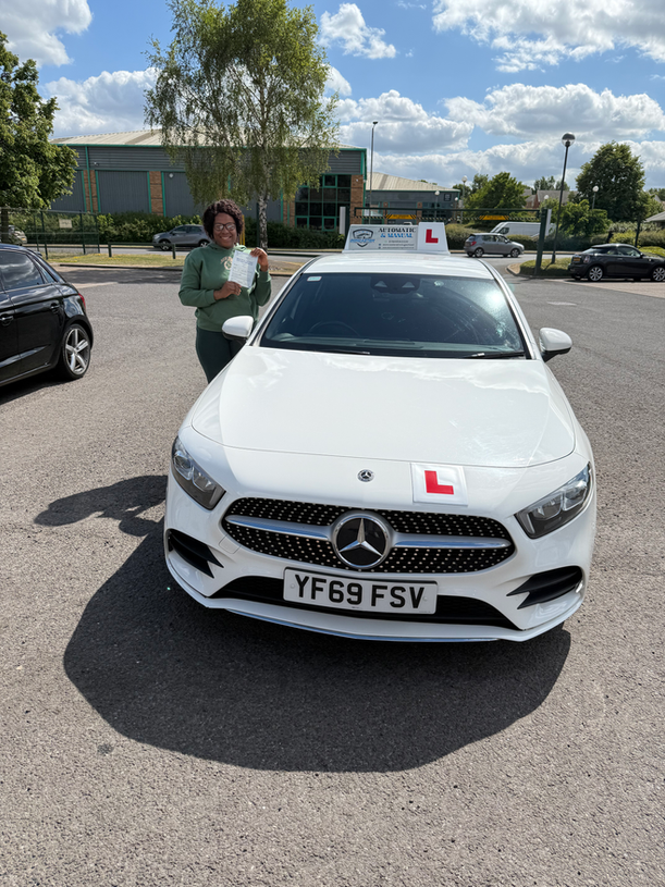 Learner driver showing driving test pass certificate with smile