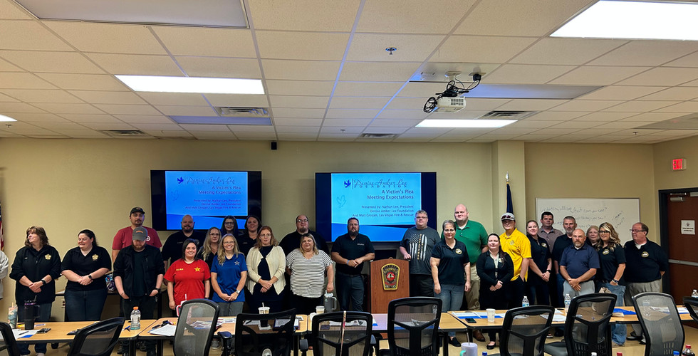 Group photo of Hawkins County 911 staff along with Southwest Virginia 911 counterparts during the Denice Amber Lee Foundation's 'A Victim's Plea' training course in Wise County, Virginia on August 13-14, 2024. The participants are standing in front of a presentation screen, marking the successful completion of a two-day, grant-funded educational event.