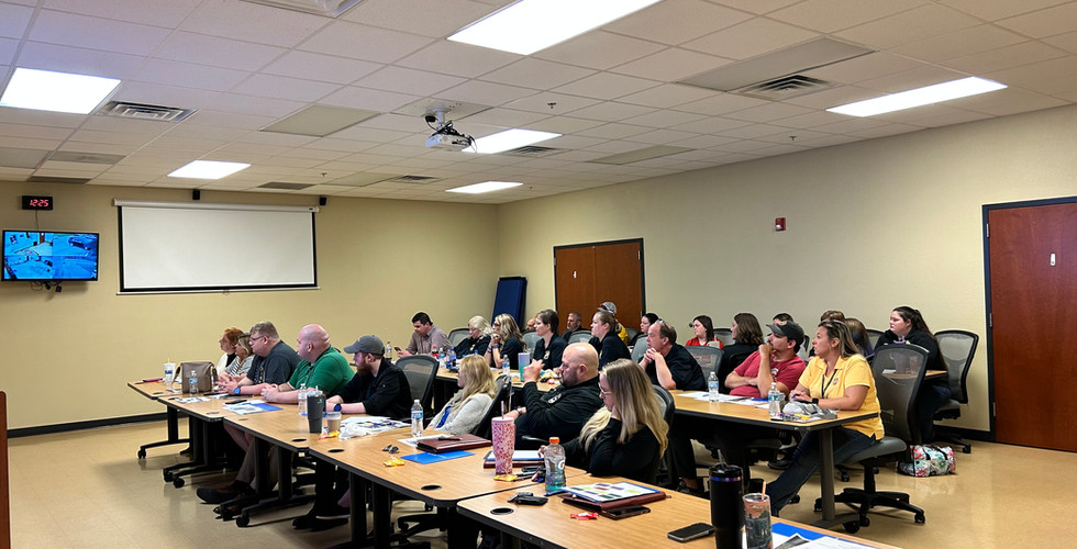 Hawkins County 911 staff members attentively participating in the Denice Amber Lee Foundation's 'A Victim's Plea' training course, hosted in Wise County, Virginia on August 13-14, 2024. The room is filled with focused 911 dispatchers as they learn from the critical events surrounding the Denise Amber Lee case.