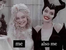 Two women dressed in contrasting fantasy costumes, one in white with long blonde hair and the other in black with dark hair and red lipstick.