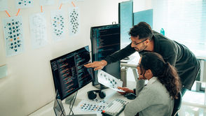 Two people reviewing code