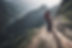 Japanese anime style trail runner's leg with an off-focus mountain at the back showing tra