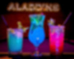 Three vibrant cocktails on a bar counter: blue, pink, and green, garnished with mint. "ALADDINS" sign glows in the dark background.