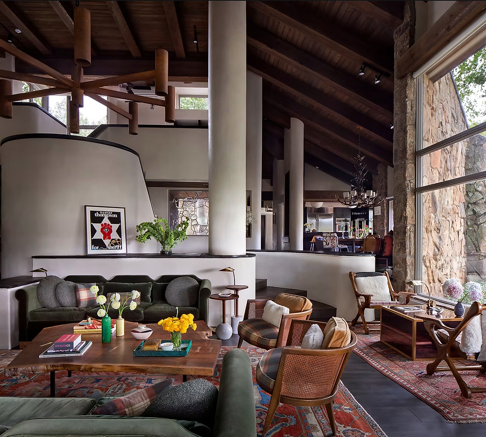 Full-service interior design on a 1980s Aspen home: retro-modern living room with mountain retreat aesthetic, blending robust architectural features with cozy, eclectic deco.