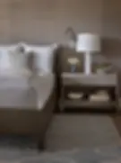 Elegant bedroom with textured grasscloth wallpaper, showcasing a modern, stylish interior design trend