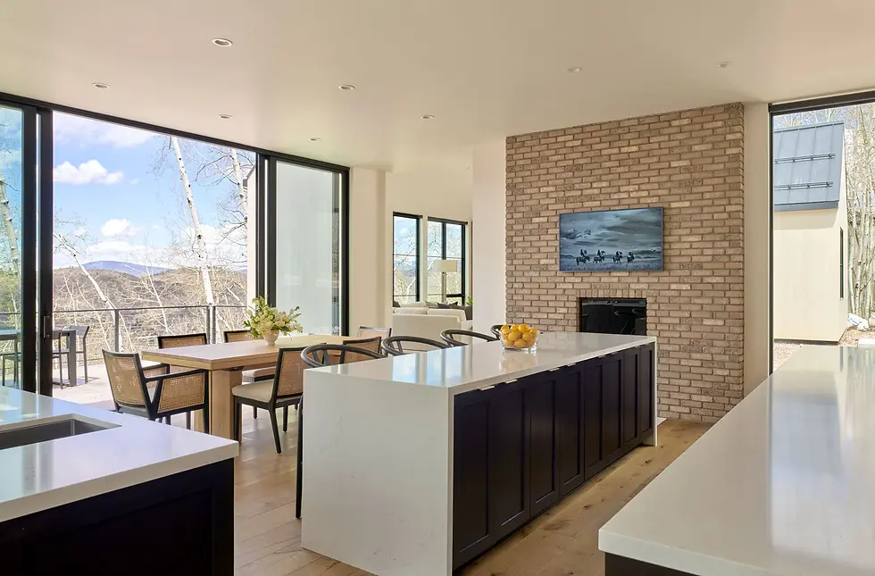 An open kitchen with a large island alongside a dining table