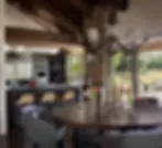 Kitchen with antler chandelier, open layout & rustic-chic elements showcasing modern ranch house design.