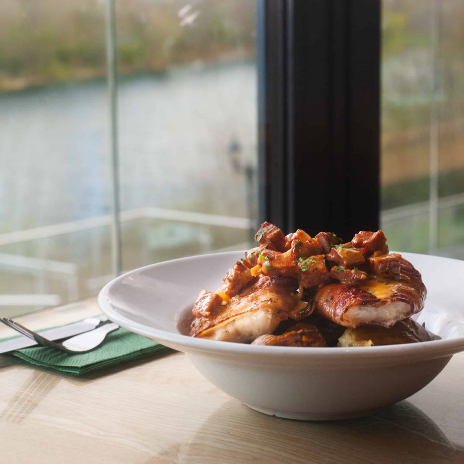 One of Casa's Mediterranean chicken dishes overlooking lake from inside the restaurant