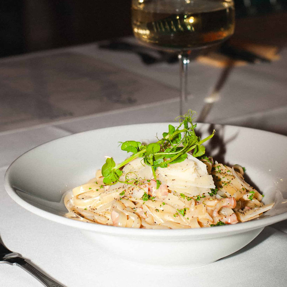 Casa's classic spaghetti carbonara with some parmesan grated over the top