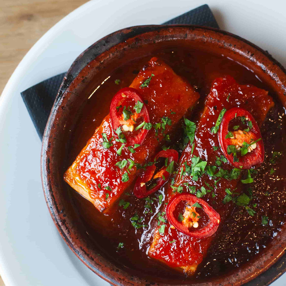 A spicy tapas small plate dish served at Casa with chillies and tomato sauce