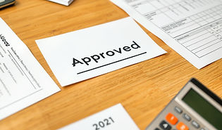 paperwork on a table, well organized and a calculator on the table, one of the documents s