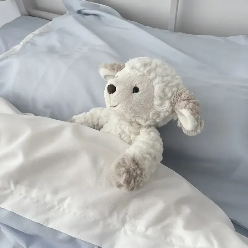 Cuddly Sheep in bed