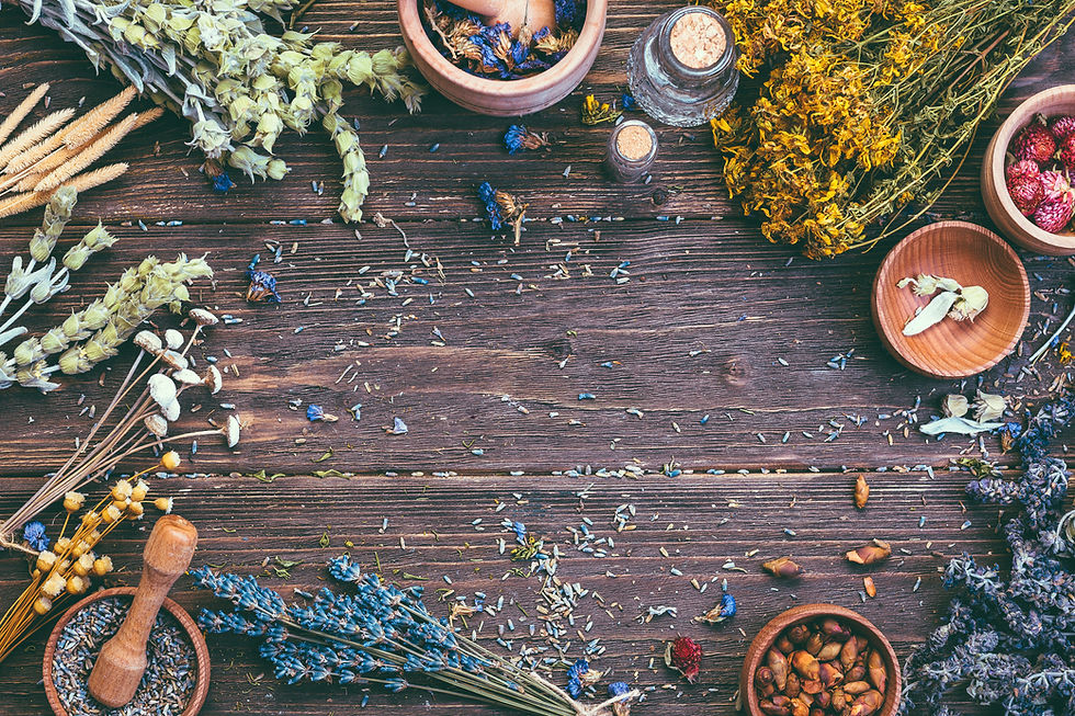 A serene wooden workspace adorned with a variety of herbs, flowers, and jars for tinctures, creating an inviting ambiance that reflects the holistic essence of Soma Ayurved.