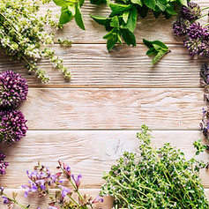 A visual representation of Core Synchronism featuring a wooden workspace surrounded by an arrangement of vibrant flowers and herbs, symbolizing balance and natural healing.