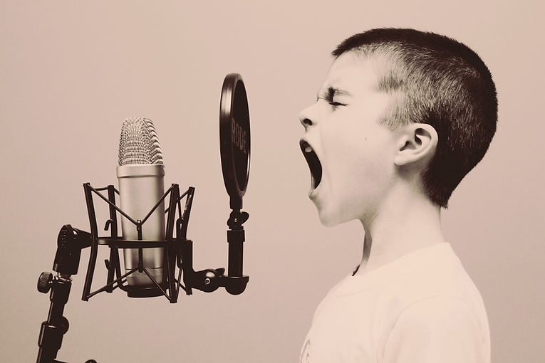 boy%20singing%20on%20microphone%20with%2