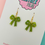 Thumbnail: Shimmering green glitter bow earrings