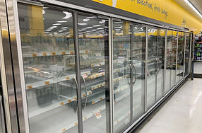 Photo of a giant tiger multi door reach in refrigeration system. Clear glass doors with multiple produce inside.