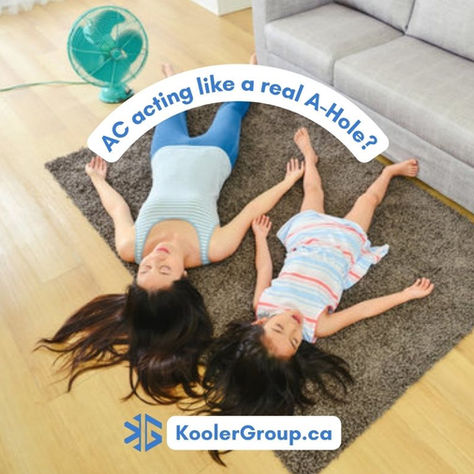 A mom and daughter laying on the ground trying to stay cool as the AC isn't working.