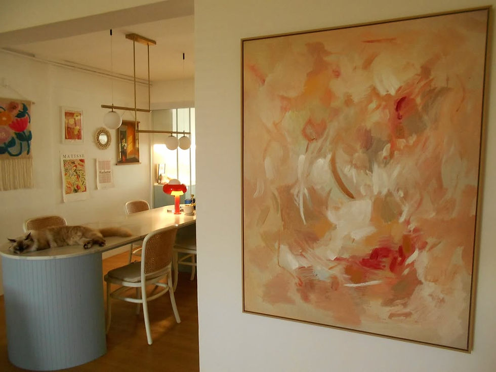 Lady hanging up a piece of vibrant Pretty Major wall art