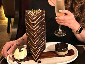 Image of a 12 layer cake and a glass of champaign