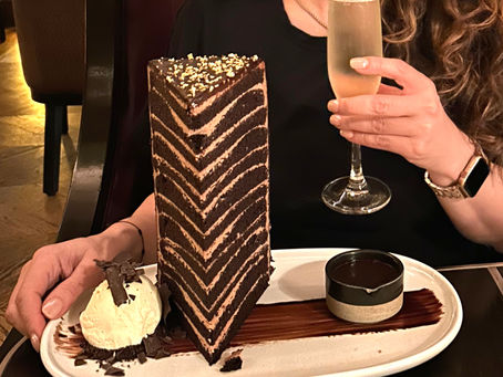 Image of a 12 layer cake and a glass of champaign