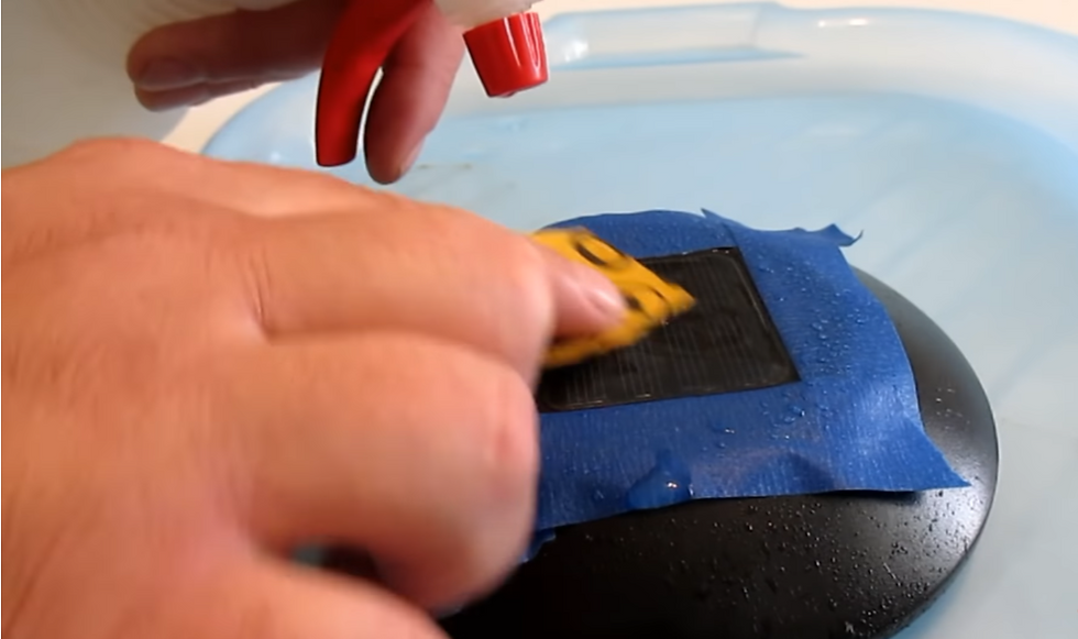 Sanding the solar panel