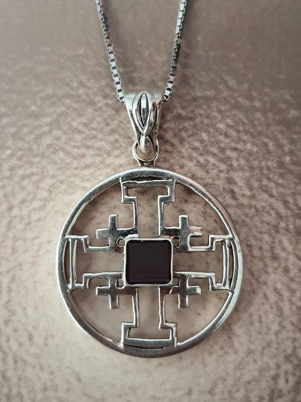 Thumbnail: Round Jerusalem Cross pendant with New testament Nano Bible sim on the beige background