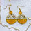 Thumbnail: Gold plated Dangle handmade round earrings orange color  with real and dried flowers